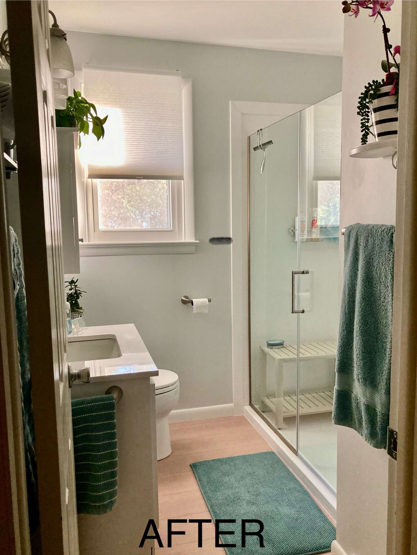 Small bathroom remodel with glass shower and teal accents