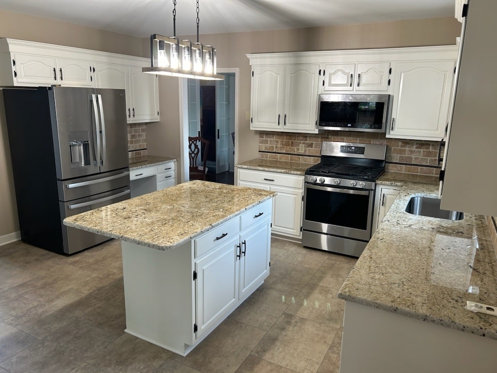 Fully remodeled kitchen with granite island and stainless steel appliances
